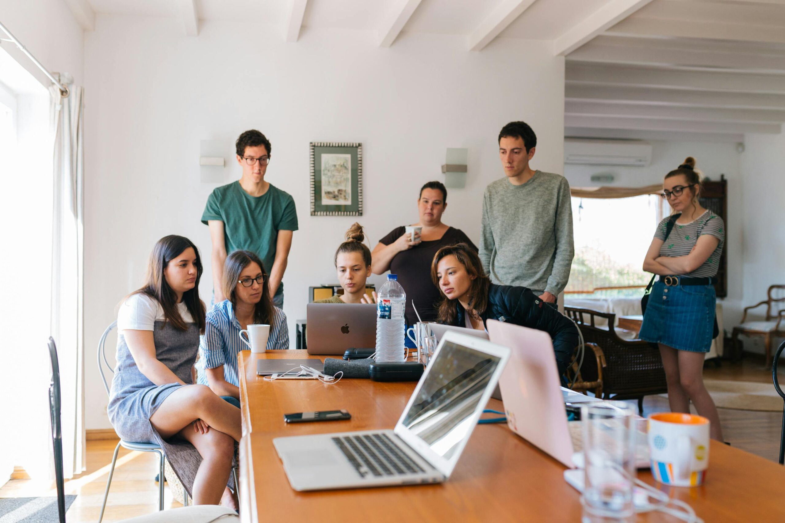 About Group of young professionals engaged in a collaborative meeting in a modern office setting.
